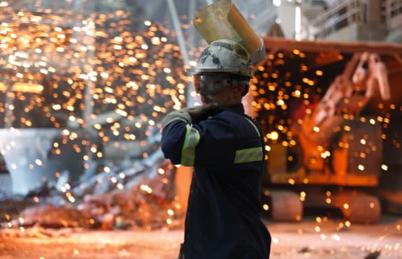 Man working with molten metal